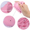 A hand is shown using a pink scalp massager shampoo brush with soft silicone bristles, highlighting its anti-slip and soft/co