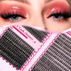 Close-up of a pink DIY Mixed Length Eyelash Extension Kit showing various lash clusters and extensions.