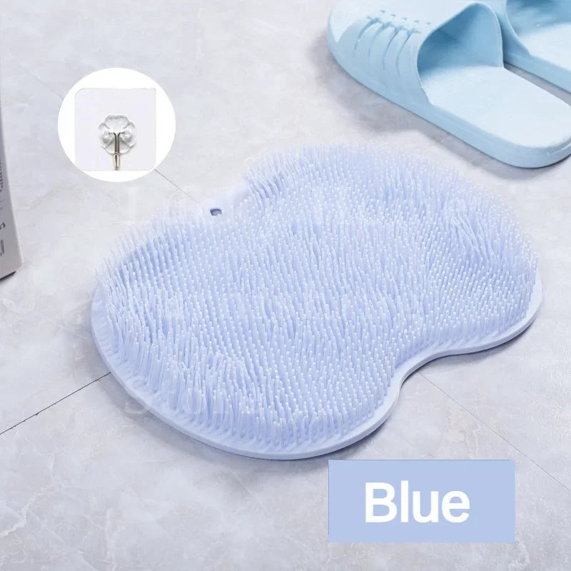 A blue silicone foot scrubber and exfoliating bath sponge are shown on a light surface.