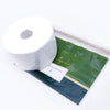 Roll of soft cotton disposable face towels for cleansing and makeup removal in green packaging