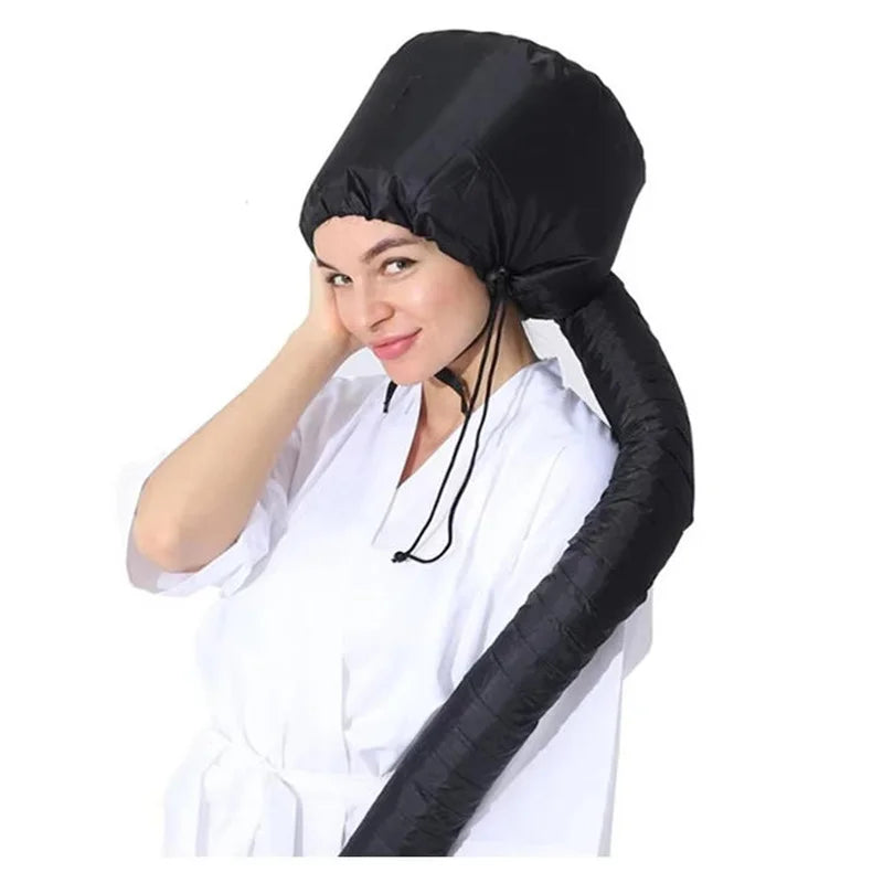 A woman wearing a black adjustable hair drying cap, demonstrating its use for salon or home drying.