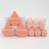 A set of twelve peach-colored makeup sponges in various cone and oval shapes displayed on a white surface.