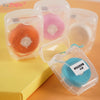 Clear plastic containers holding various colored nylon dental floss for oral hygiene