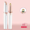 A white electric eyebrow trimmer and epilator with a gold tip shown in a product display.