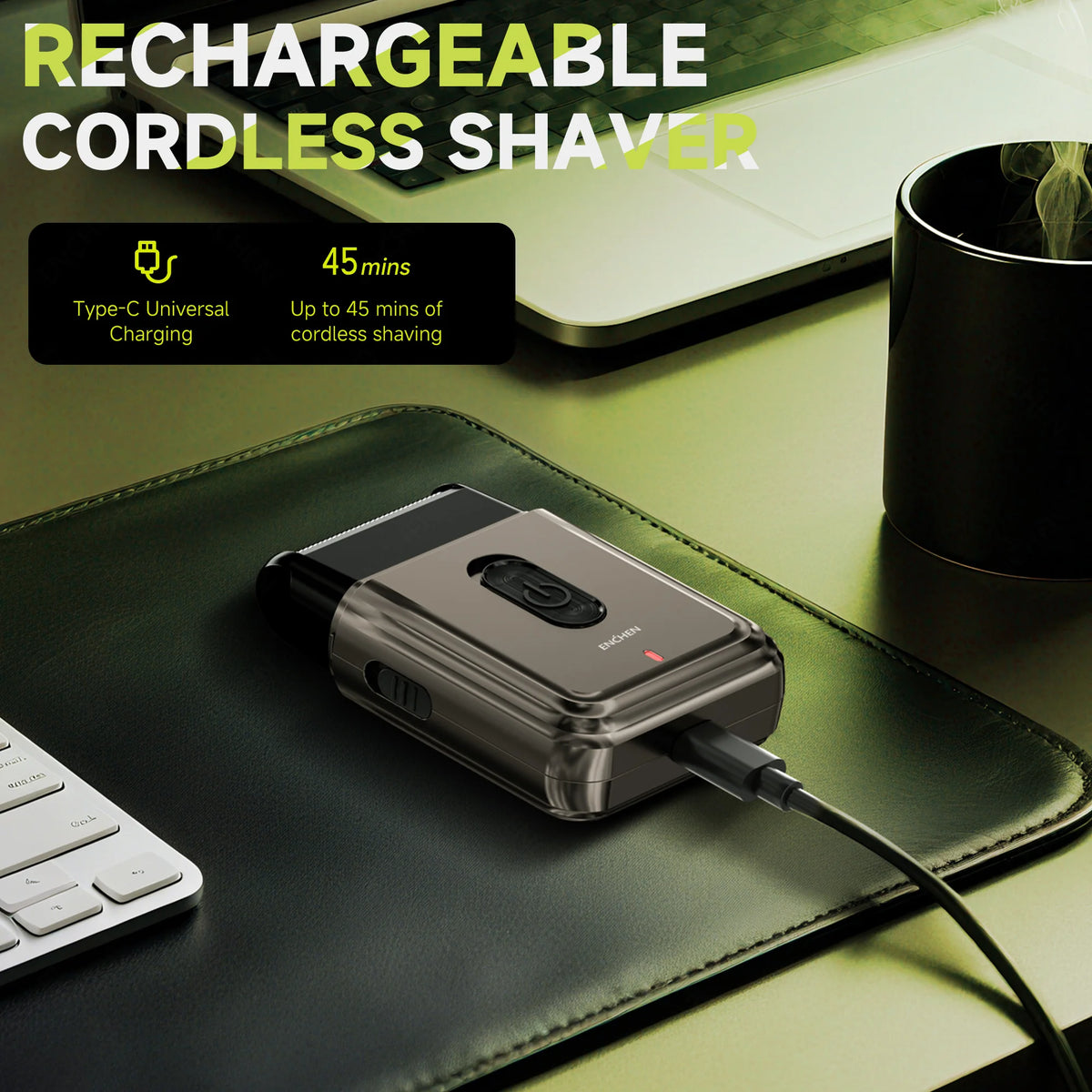 A portable rechargeable cordless shaver resting on a dark green leather mat next to a laptop.