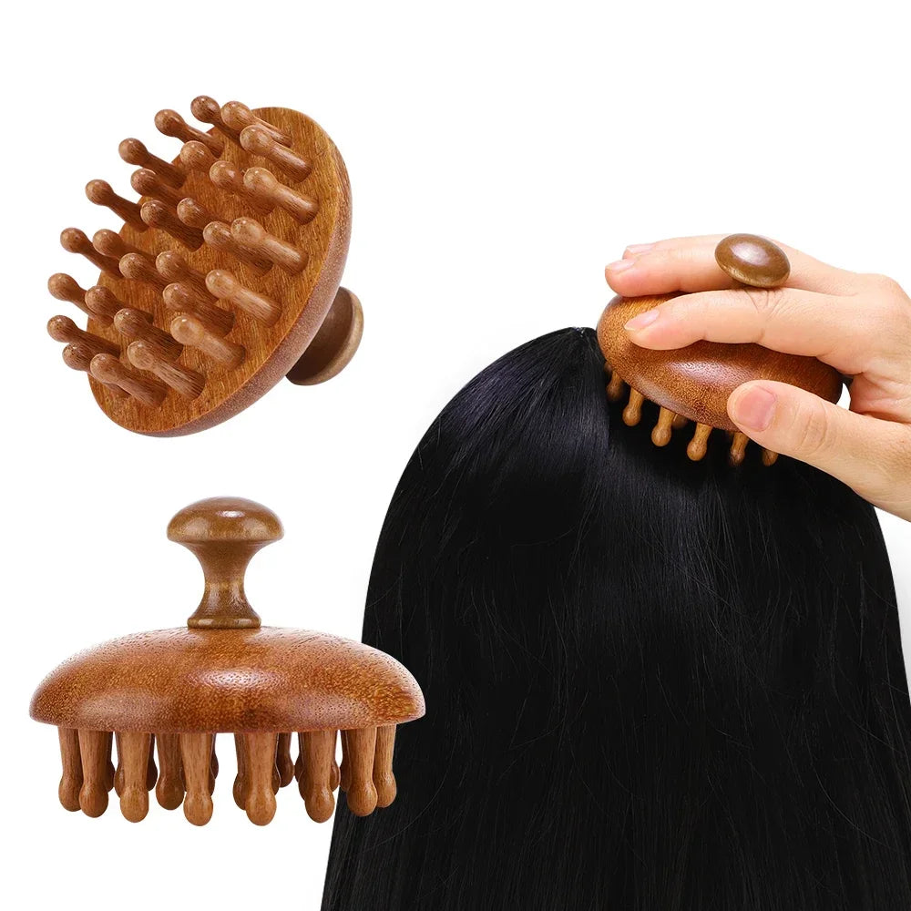 A hand is holding a wooden natural sandalwood therapy massage comb, showing its texture and shape against dark hair.