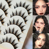 A collection of black Paris Cat Eye false eyelashes displayed on a white tray.