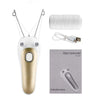 A white electric hair remover device with a gold tip and accompanying accessories shown next to an instruction book.