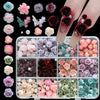 A collection of 3D floral butterfly pearl nail art charms in various shades of pink, red, and green.