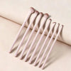 A set of professional makeup brushes for loose powder, arranged diagonally on a light surface.