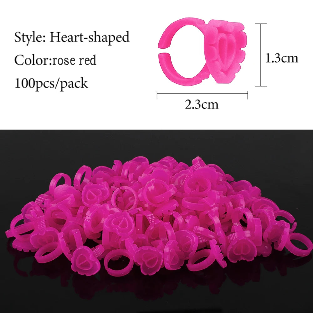 A pile of pink heart-shaped disposable glue rings for eyelash extensions and nail art