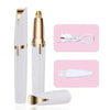 A white portable electric trimmer with a gold tip and a white plastic comb attachment.