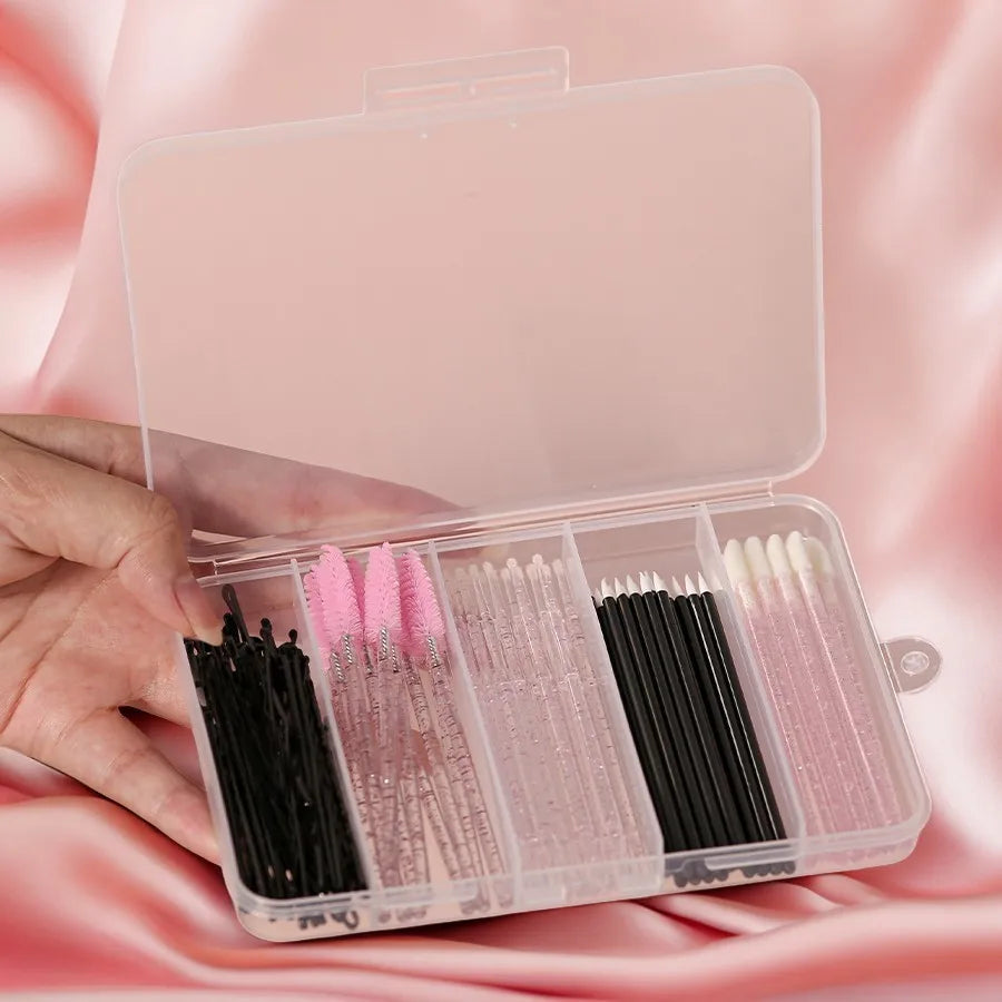 A hand holds an open clear storage case containing 80 makeup brushes in various shades and sizes.