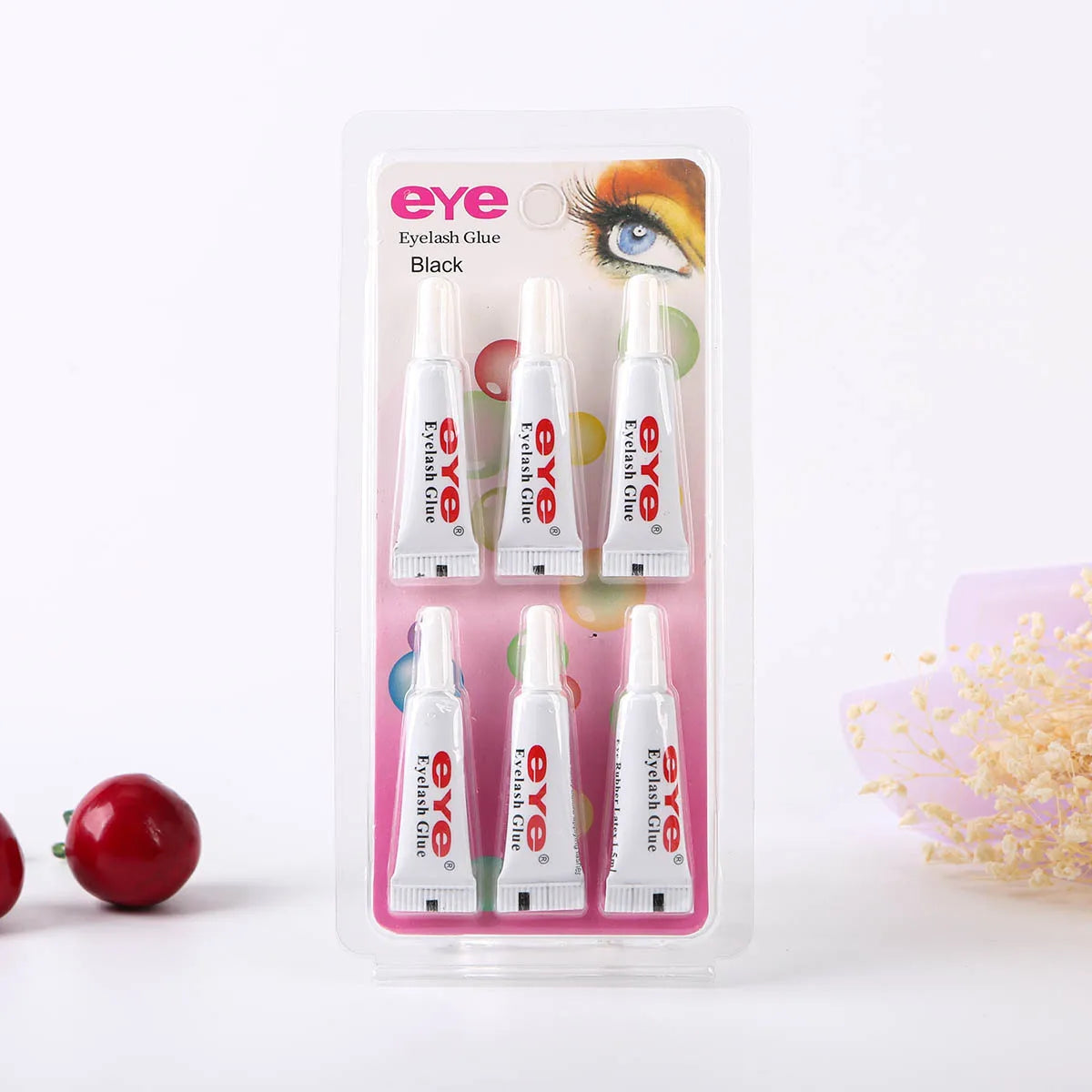 A clear plastic case containing several tubes of Eye Glue eyelash glue in black.