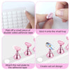 A set of nail practice stands and pink nail art designs attached to double-sided adhesive tape.