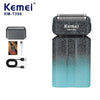 A Kemei KM-T396 electric foil shaver with a dark gray and teal body and charging cord.