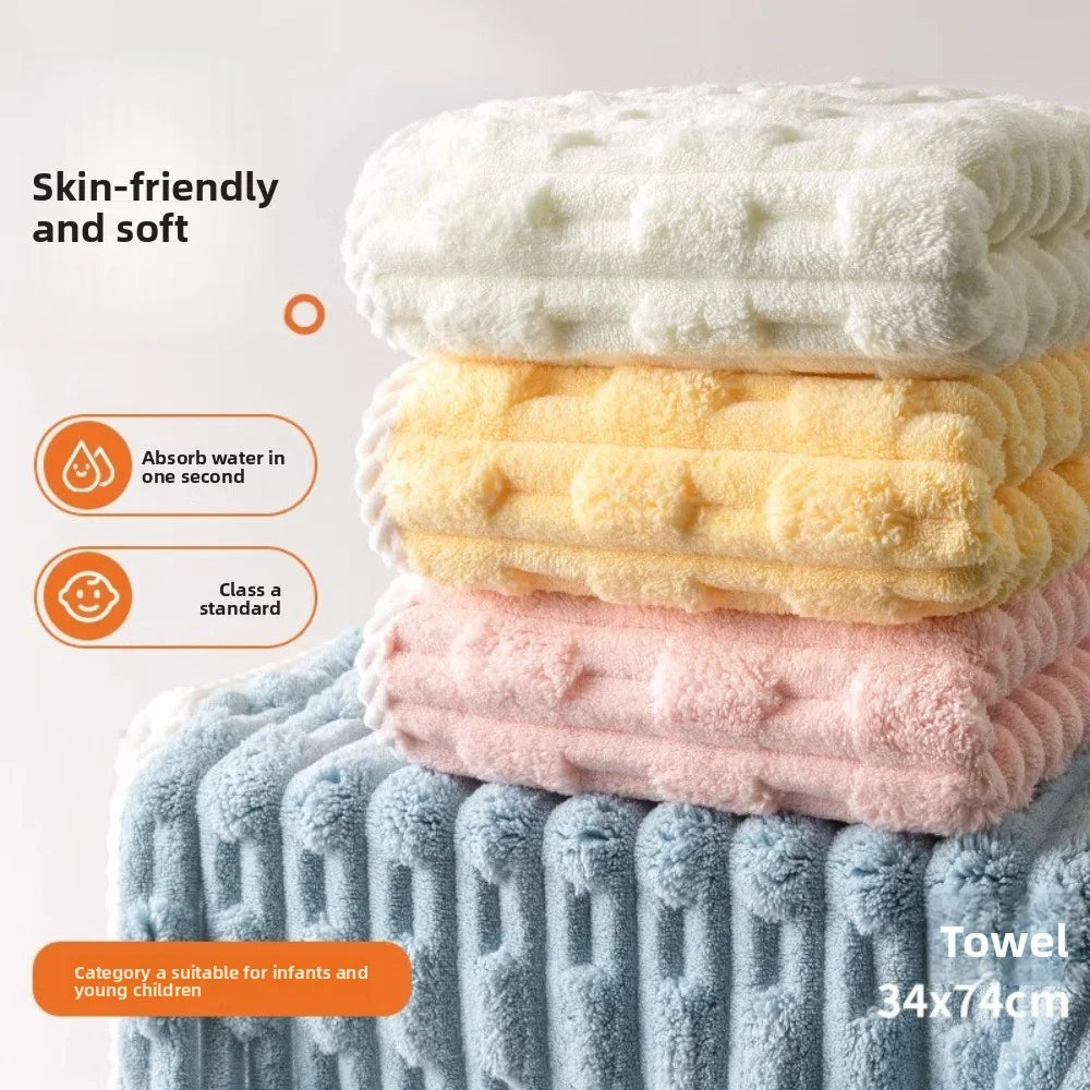Pile de serviettes de bain moelleuses blanches, jaunes et roses avec une serviette bleue texturée visible.