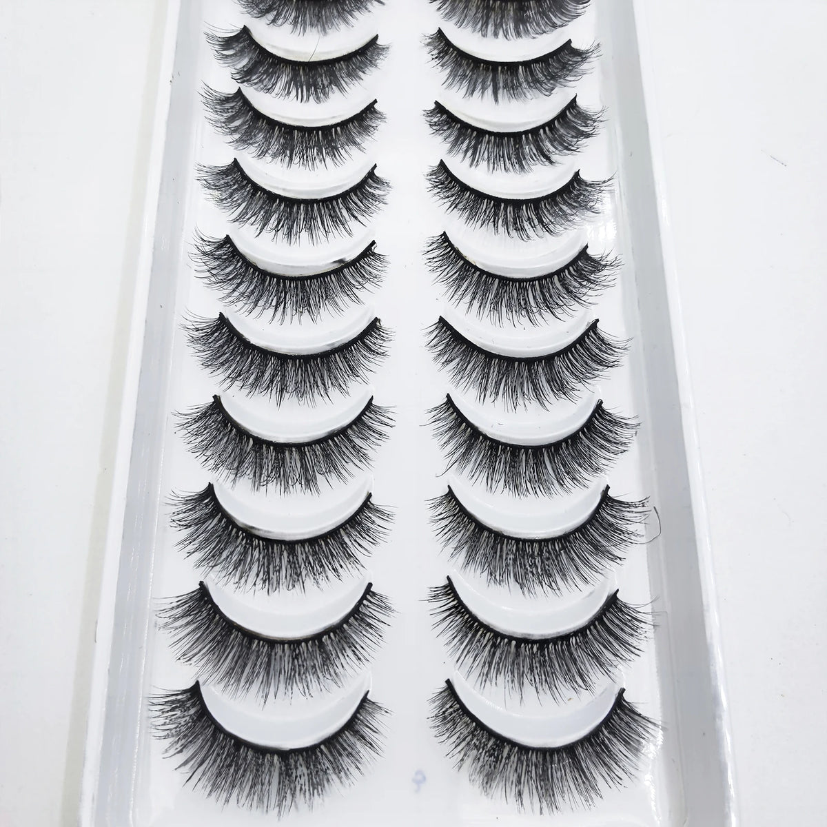 A tray of natural 3D mink false eyelashes displayed in rows.