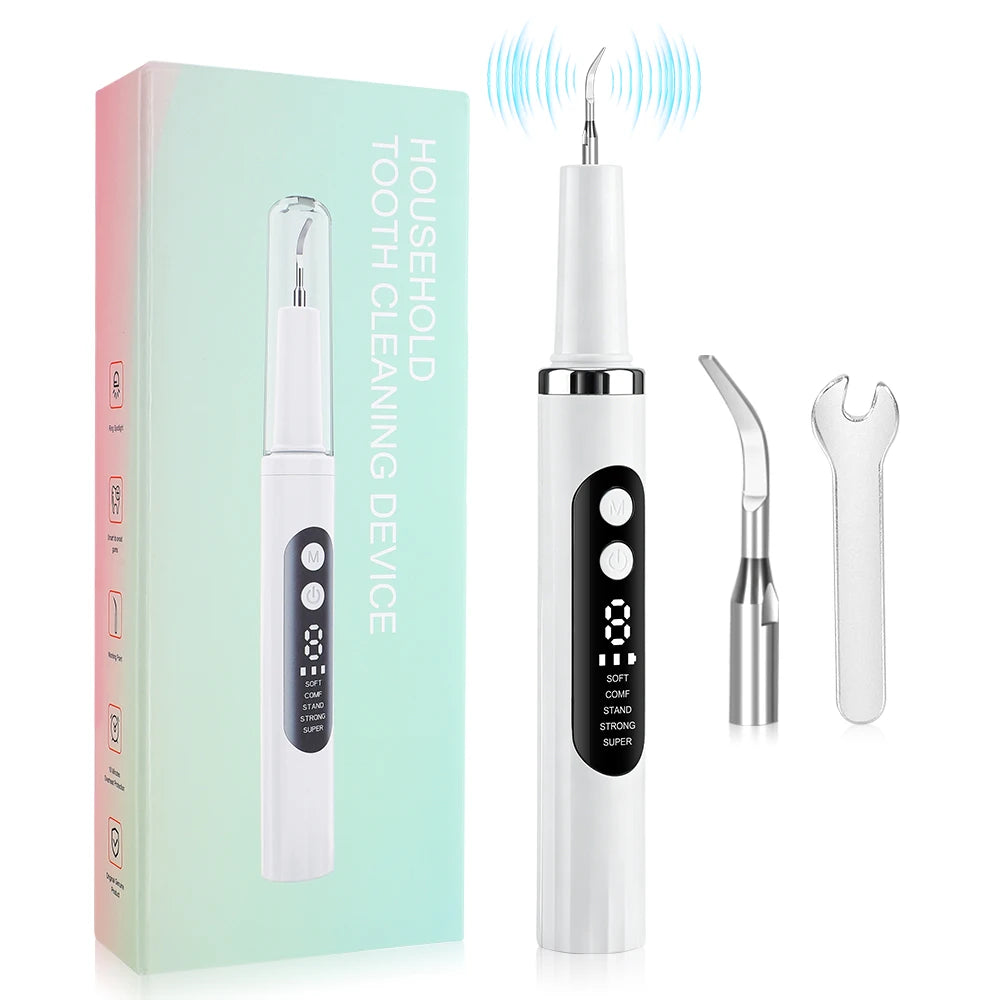A white household tooth cleaning device with a clear applicator and a separate dental scaler tool is shown next to its packag