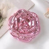 A pink vintage rose design double-sided pocket makeup mirror resting on a white surface.