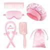Un ensemble d'outils de coiffure roses comprenant un peigne, un coussin en silicone, une brosse et un bonnet de cheveux satin