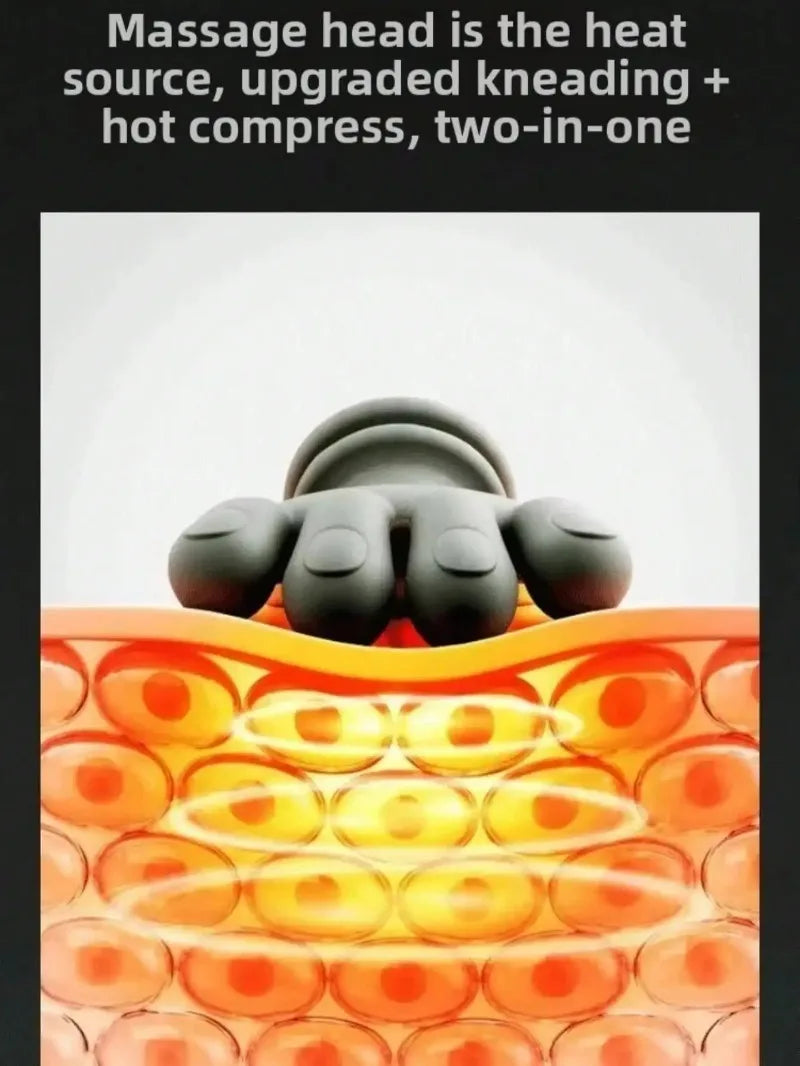 A close-up of a black massage head device is shown resting on an orange, textured surface.