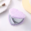 A heart-shaped foldable travel makeup mirror covered in fluffy purple faux fur.