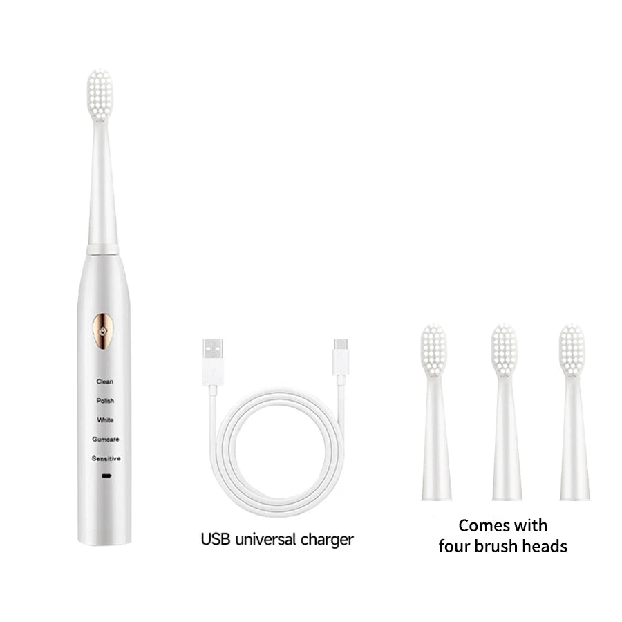 Cepillo eléctrico plateado y cuatro cabezales con cargador universal USB.