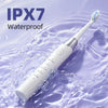 A white electric toothbrush is shown submerged in water, demonstrating its IPX7 waterproof rating.