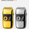A pair of Kemei electric shavers, one gold and one silver, shown side by side.