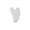 A white heart-shaped jade gua sha facial stone.