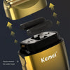 A close-up view of a gold and black electric foil shaver with a removable cutter head.