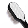 A black toothbrush with a white head and soft bristles is shown against a white background.