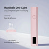 A pink handheld one-light nail dryer with a black rectangular section and an indicator light.