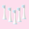 White replacement toothbrush heads for kids electric toothbrushes displayed against a pink background.