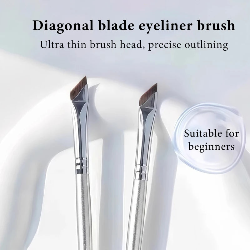 A pair of diagonal blade eyeliner brushes shown against a white background with a clear container.