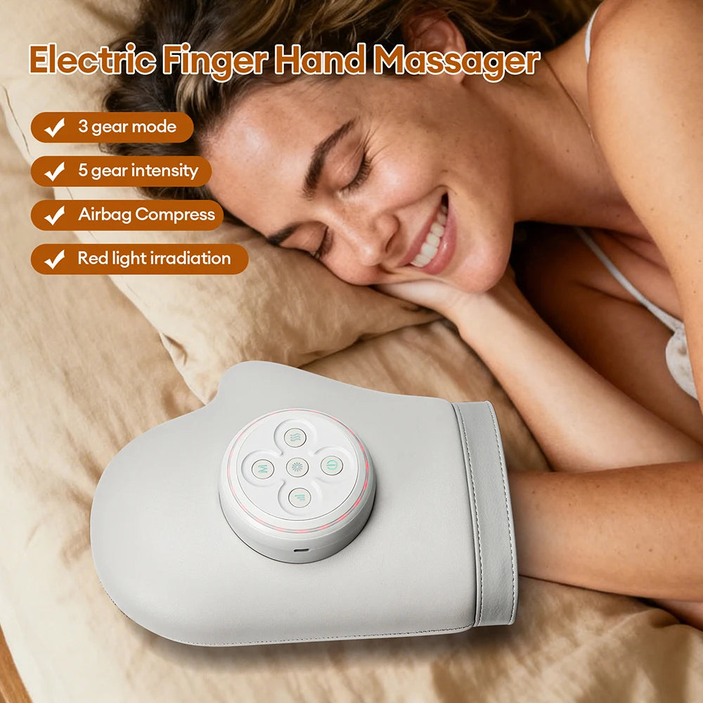 A woman is using a handheld electric finger hand massager with a control panel, relaxing on a couch.