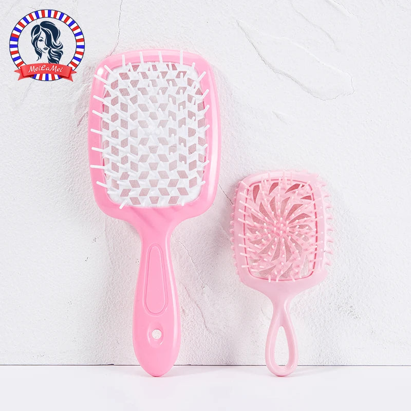 A pink detangling hair comb is shown against a white background.
