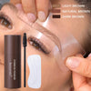 A close-up of a person applying eyebrow powder using a waterproof stamp kit, stencils, and brush on their face.