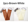 Two brown and white exfoliating body scrub sponges with purple loops shown against a white background.