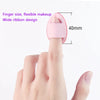 A pink silicone applicator tool designed for finger size makeup application with a wide ribbon design.
