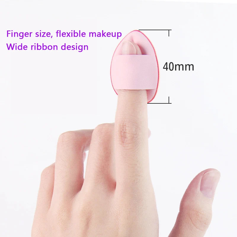 A pink silicone applicator tool designed for finger size makeup application with a wide ribbon design.