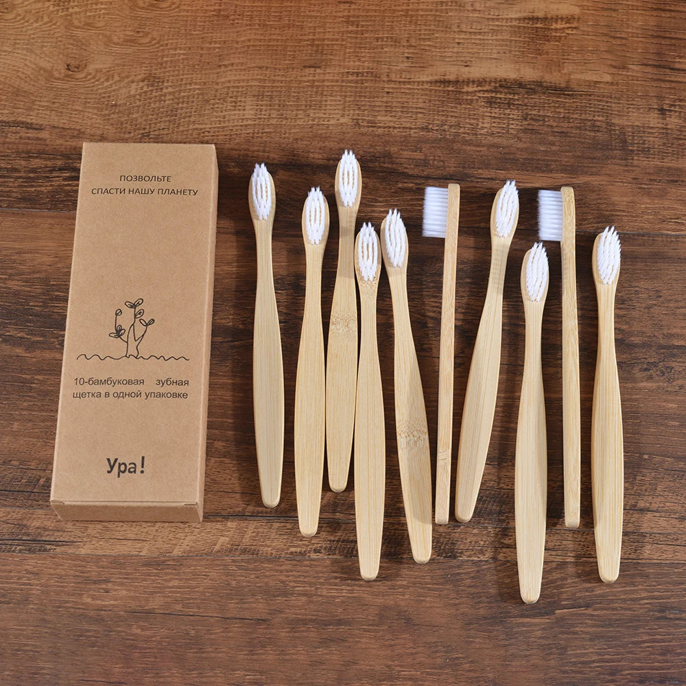 A set of ten natural bamboo toothbrushes displayed on a wooden surface.