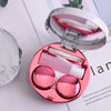 A pink round marble pattern contact lens storage box open to show clear contact lenses inside.