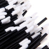 A close-up view of a set of black and white precision makeup brushes.