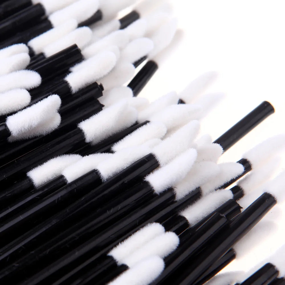 A close-up view of a set of black and white precision makeup brushes.