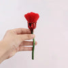 A hand holds a red rose flower nail art dust brush set with a vibrant red fluffy brush head.