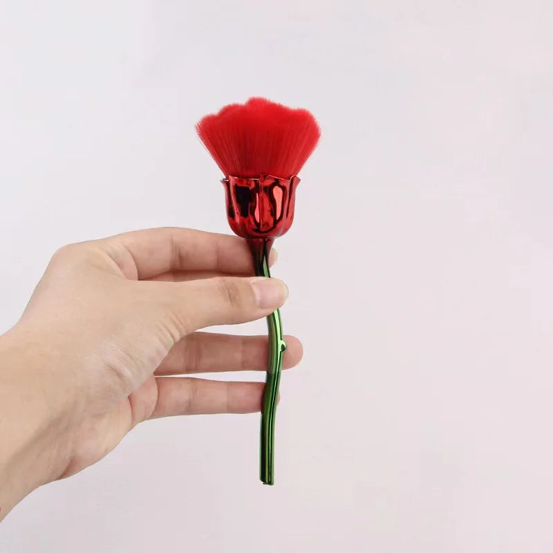 A hand holds a red rose flower nail art dust brush set with a vibrant red fluffy brush head.