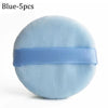 A round, light blue velvet makeup puff with a blue strap.