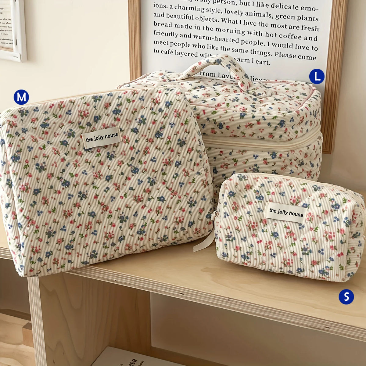 Three quilted cotton makeup bags in floral patterns are displayed on a wooden shelf.